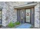 Modern front door with stonework and landscaping at 37200 N Cave Creek Rd # 1119, Scottsdale, AZ 85262