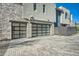 Two-car garage with modern glass doors and paved driveway at 37200 N Cave Creek Rd # 1119, Scottsdale, AZ 85262