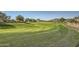 Lush green golf course with a paved pathway and mountain views at 37200 N Cave Creek Rd # 1119, Scottsdale, AZ 85262