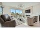 Spacious living room with stone fireplace, large windows, and comfortable seating at 37200 N Cave Creek Rd # 1119, Scottsdale, AZ 85262