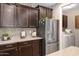 Kitchen features stainless steel refrigerator and ample cabinetry at 3836 E Gideon Way, Gilbert, AZ 85296