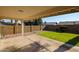 Covered patio overlooking a grassy backyard with block wall fencing at 4235 E Hano St, Phoenix, AZ 85044