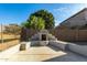 Outdoor stucco fireplace in the backyard at 43576 W Snow Dr, Maricopa, AZ 85138