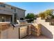 Stainless steel built-in grill with stone countertop at 43576 W Snow Dr, Maricopa, AZ 85138