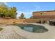 Inviting kidney-shaped pool with rock waterfall feature at 438 E Palomino Way, San Tan Valley, AZ 85143