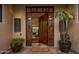 Elegant entryway with rich wood door and welcome mat at 5622 E Sugarloaf Trl, Cave Creek, AZ 85331