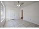 Bright bedroom with tile floors, ceiling fan, and ample closet space at 6426 W Saguaro Dr, Glendale, AZ 85304