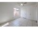 Well-lit bedroom featuring tile flooring and a ceiling fan at 6426 W Saguaro Dr, Glendale, AZ 85304