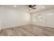 Living room featuring wood-look tile floors and ceiling fan at 6449 W Hatcher Rd, Glendale, AZ 85302