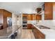 Modern kitchen with stainless steel appliances and wood cabinetry at 7255 N 12Th St, Phoenix, AZ 85020