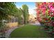 Landscaped backyard with artificial turf and bougainvillea at 7330 E Palo Verde Dr # 9, Scottsdale, AZ 85250