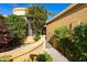 gated entry to a house with lush landscaping at 7330 E Palo Verde Dr # 9, Scottsdale, AZ 85250