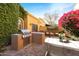 Outdoor patio with built-in grill, seating area, and dining table at 7330 E Palo Verde Dr # 9, Scottsdale, AZ 85250