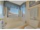 Bathroom with a shower and toilet, updated fixtures, and large window at 8142 W Maryland Ave, Glendale, AZ 85303