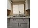 Kitchen features a double sink and white cabinets at 8600 E Broadway Rd # 55, Mesa, AZ 85208