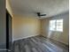 Bedroom with ceiling fan and wood-look flooring at 8741 N 105Th Dr, Peoria, AZ 85345