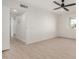 Spacious bedroom featuring a ceiling fan and hardwood-style flooring at 9747 W Royal Ridge Dr, Sun City, AZ 85351