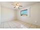 Bright bedroom with tiled floors and a ceiling fan at 1017 E Wesleyan Dr, Tempe, AZ 85282