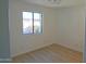 Simple bedroom with wood-look floors and window at 1217 N Miller Rd # 8, Scottsdale, AZ 85257