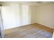 Simple bedroom with wood-look floors and window at 1217 N Miller Rd # 8, Scottsdale, AZ 85257