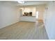 Spacious living room with light wood floors and kitchen views at 1217 N Miller Rd # 8, Scottsdale, AZ 85257