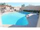 Community pool with surrounding lounge chairs at 1217 N Miller Rd # 8, Scottsdale, AZ 85257