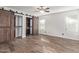 Main bedroom with barn doors, wood floors and built-in shelves at 13100 N 80Th Ave, Peoria, AZ 85381