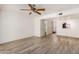 Living area with laminate flooring, ceiling fan and bathroom access at 1328 S Mckemy St, Tempe, AZ 85281