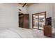 Bedroom with access to a private patio, modern finishes, and a TV at 13420 E Jomax Rd, Scottsdale, AZ 85262