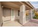 Covered front porch with textured stucco columns, a brown door, and side railings at 1410 W Flintlock Way, Chandler, AZ 85286