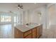 View of the kitchen island and open concept living area with tile flooring at 1410 W Flintlock Way, Chandler, AZ 85286