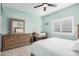 Well-lit bedroom with a queen bed, dresser, and ceiling fan at 15225 N 100Th St # 2224, Scottsdale, AZ 85260