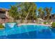 Community pool with waterfall feature and lounge chairs at 15225 N 100Th St # 2224, Scottsdale, AZ 85260