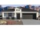 Single-story home with a two-car garage and desert landscaping at 1555 E Mason Dr, Casa Grande, AZ 85122