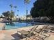 Community pool with lounge chairs at 201 S Greenfield Rd # 154, Mesa, AZ 85206