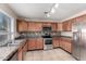 Kitchen with stainless steel appliances and wood cabinets at 23582 W Wier Ave, Buckeye, AZ 85326