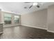 Spacious living room with dark wood-look floors and neutral walls at 240 W Juniper Ave # 1058, Gilbert, AZ 85233