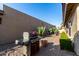 Landscaped backyard with built-in grill and cactus plants at 25401 S Cloverland Dr, Sun Lakes, AZ 85248