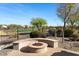 Curved fire pit with seating area in the backyard at 27238 W Mohawk Ln, Buckeye, AZ 85396