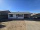 Front exterior view of a single-story home with a carport and surrounding desert landscape at 312 N Madison St, Wickenburg, AZ 85390