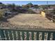 A view from a deck of a fenced yard with a dirt surface and a rock border at 312 N Madison St, Wickenburg, AZ 85390