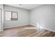 Simple bedroom with wood flooring and a window at 35920 W Cartegna Ln, Maricopa, AZ 85138