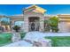 Front entry of a tan house with a decorative stone pathway and lush landscaping at 3762 S Rosemary Dr, Chandler, AZ 85248