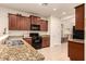 Kitchen with granite countertops and dark wood cabinets at 4486 W Crescent Rd, Queen Creek, AZ 85144