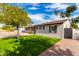 Side view of the home showcasing landscaping and driveway at 4725 N 14Th Ave, Phoenix, AZ 85013