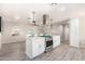 Modern kitchen with island, stainless steel appliances, and white cabinetry at 4725 N 14Th Ave, Phoenix, AZ 85013