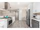 Updated kitchen with stainless steel appliances and white cabinets at 4725 N 14Th Ave, Phoenix, AZ 85013