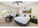 Cozy bedroom with a desk, chair, and arched window at 6721 E Jean Dr, Scottsdale, AZ 85254