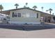 Single-wide manufactured home with covered porch and desert landscaping at 7807 E Main St # Cc-68, Mesa, AZ 85207