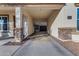 Covered walkway to garage, featuring stone pillars and a concrete driveway at 853 E Rawhide Ct, Gilbert, AZ 85296